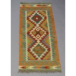 A white, green and turquoise Chobi Kilim runner with 3 diamonds to the centre 146cm x 60cm