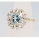 An 18ct yellow gold aquamarine and diamond cluster ring, the centre stone approx 1.5ct, surrounded