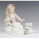 A Lladro figure of a seated girl with a rabbit 6931 14cm