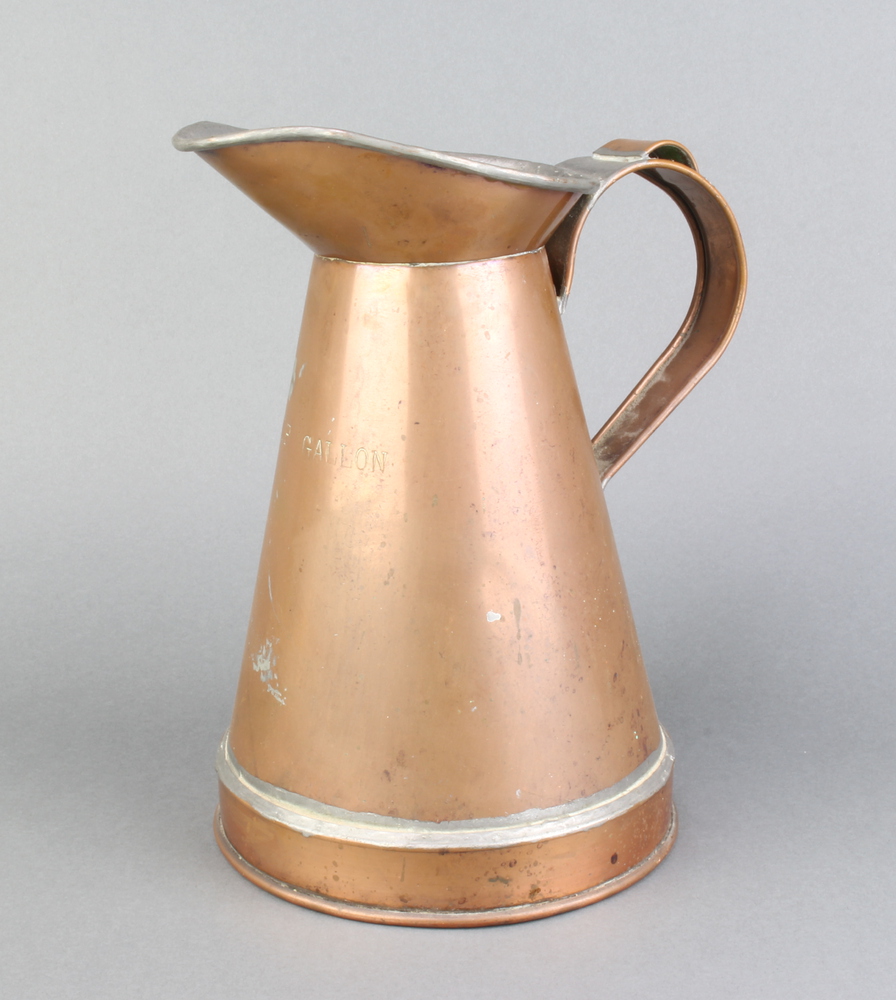 A waisted copper half gallon jug 26cm h x 17cm There is an old repair to the handle and base