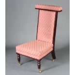 An Edwardian mahogany show frame prie-dieu chair with upholstered seat and back, raised on turned