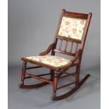 A late Victorian mahogany rocking chair with upholstered seat and back