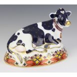 A Royal Crown Derby Imari pattern paperweight of Friesian Cow Buttercup with gold stopper 17cm