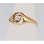An 18ct yellow gold diamond whorl shaped ring, size M 1/2, approx. 0.15ct, 2.7 grams