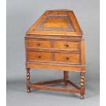 A 1930's oak corner bureau, the carved fall front revealing a fitted interior, the base fitted 2