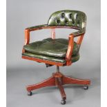 A mahogany framed revolving office chair upholstered in green buttoned leather