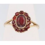 A 9ct yellow gold garnet cluster ring, size O 1/2, 1.7 grams