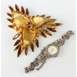 A lady's Accurist silver and marcasite watch and a spray brooch