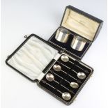 A pair of silver napkin rings Birmingham 1942 cased and a set of 6 bean end silver coffee spoons