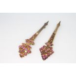 A near pair of Indian silver gilt gem set pins 10cm Several stones are missing