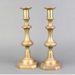 A pair of 19th Century brass candlesticks with ejectors 31cm h x 11cm w x 11cm d