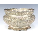 An Indian repousse silver flared rim baluster bowl decorated with formal flowers, 26cm, 1136 grams