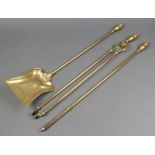 A Victorian brass Adam style 3 piece fireside companion set, all with lidded urn finials