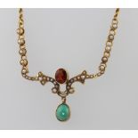 An Edwardian 9ct yellow gold garnet, seed pearl and turquoise necklace on a 9ct chain 40cm