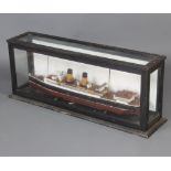A wooden model of the two funnelled liner Anglia contained in an ebonised and glazed case 46cm h x