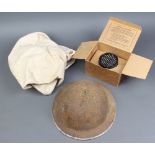 A British steel helmet (no liner), a World War Two Civilian gas mask and box together with a