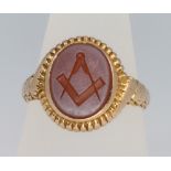 A 15ct yellow gold carved Masonic agate ring size Q, 5.5 grams