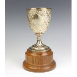 A Victorian repousse silver presentation goblet with inscription and floral motifs 16cm, 250