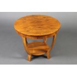 An Art Deco circular walnut 2 tier occasional table with quarter veneered top, raised shaped