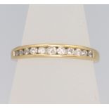 An 18ct yellow gold channel set diamond ring approx. 0.25ct, size M, 2 grams