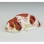 A Royal Crown Derby Imari pattern paperweight of a puppy with gold stopper, 3cm