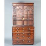 A Georgian mahogany secretaire bookcase, the upper section with moulded cornice, fitted adjustable