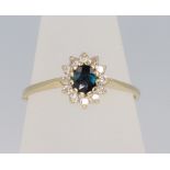 An 18ct yellow gold sapphire and diamond cluster ring size N