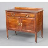 An Edwardian mahogany wash stand with raised back, the base fitted a drawer above panelled doors,