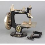A child's Singer USA sewing machine with clamp