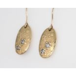 A pair of 9ct yellow gold diamond set oval earrings, 3 grams