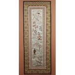 A Chinese silk work embroidery, figures in an extensive landscape 75cm x 25cm