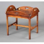 A Georgian style mahogany drop flap butler's table raised on square tapered supports with H framed