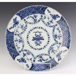 An 18th Century Chinese plate, the centre decorated with a vase of flowers enclosed by a border of