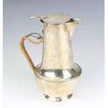 A stylish silver hot water jug with woven handle and armorial, Sheffield 1924, 19cm, gross weight