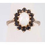 A 9ct yellow gold opal and garnet cluster ring, size N, 3.3 grams