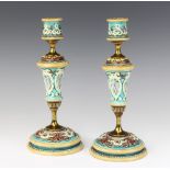 A pair of Doulton Lambeth candlesticks the turquoise ground with classical figures having gilt metal