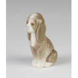 A Lladro figure of a seated puppy hound 8cm