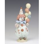 A Lladro figure of a child clown holding balloons 5811 18cm