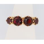 A 9ct yellow gold 4 stone garnet ring, size K, 2.7 grams