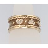 A 9ct yellow gold band set with 6 diamond hearts, size Q, 7.3 grams