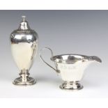 An Edwardian baluster silver shaker London 1910 and a pedestal jug Sheffield 1939, 260 grams