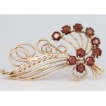 A 9ct yellow gold garnet spray brooch 56mm