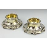 A pair of Victorian cast silver table salts with scroll decoration, London 1847, maker Charles