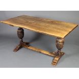A 17th Century style rectangular elm refectory dining table raised on cup and cover supports with