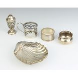 A silver shell shaped butter dish, Sheffield 1920, pepper, holder, napkin ring and salt, 150 grams