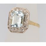An 18ct yellow gold aquamarine and diamond ring, the centre stone 3.1ct surrounded by brilliant