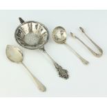 A Peruvian silver strainer and minor flatware, 106 grams