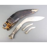 A Kukri, the blade marked India Handcrafted centre, the "silver" grip with lion mask decoration