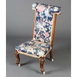 A Victorian mahogany show frame prie-dieu chair upholstered in blue floral material, raised on