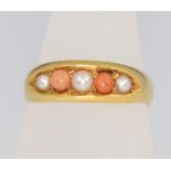 An 18ct yellow gold coral and pearl ring size N 1/2, 3.2 grams